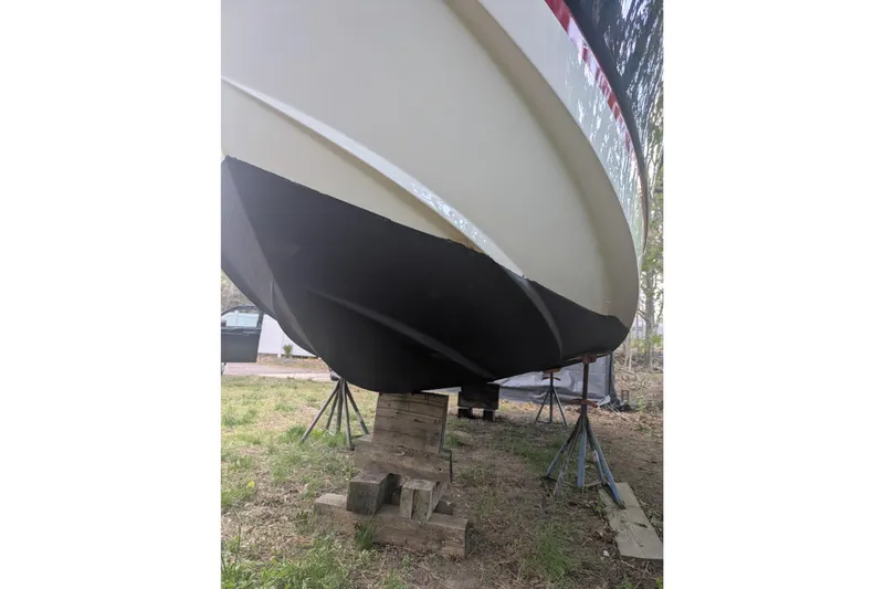 Slide: The Image of 2016 Wellcraft 252 Coastal boat hull on stands, viewed from below. - 11