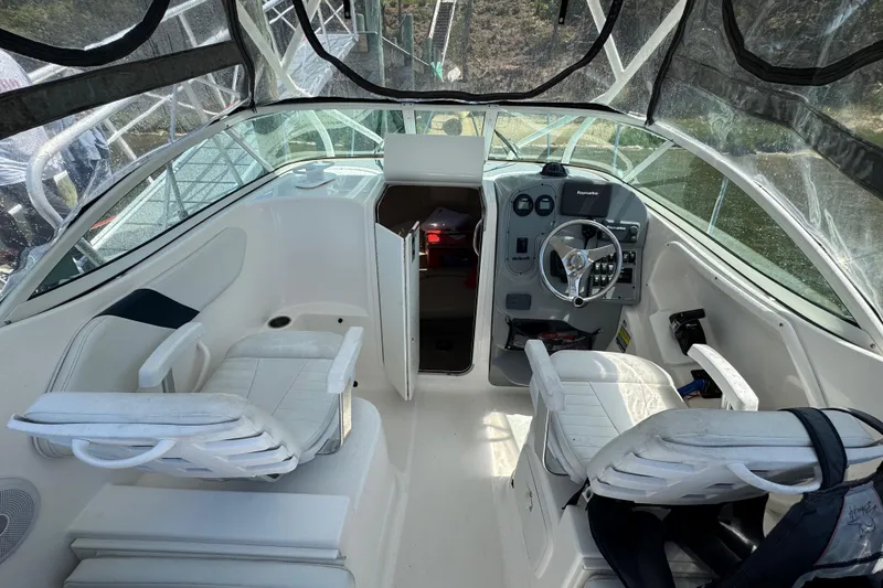 Slide: The Image of 2016 Wellcraft 252 Coastal boat interior with steering wheel and seating. - 17