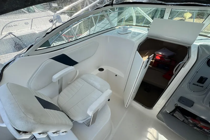 Slide: The Image of Interior of 2016 Wellcraft 252 Coastal boat with white seating and cabin access. - 18