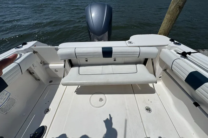 Slide: The Image of 2016 Wellcraft 252 Coastal boat interior with seating and outboard motor. - 25