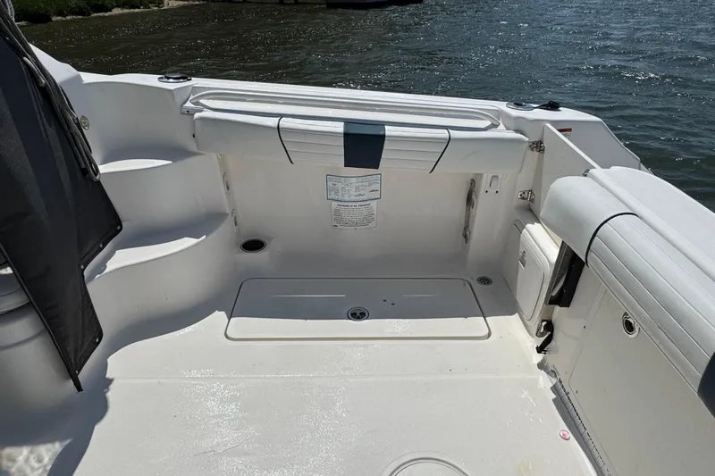 Slide: The Image of 2016 Wellcraft 252 Coastal boat interior with seating and storage, near water. - 26