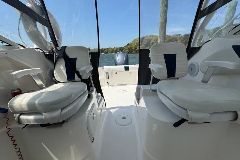 Slide: The Image of Interior view of 2016 Wellcraft 252 Coastal boat with seating and water backdrop. - 28