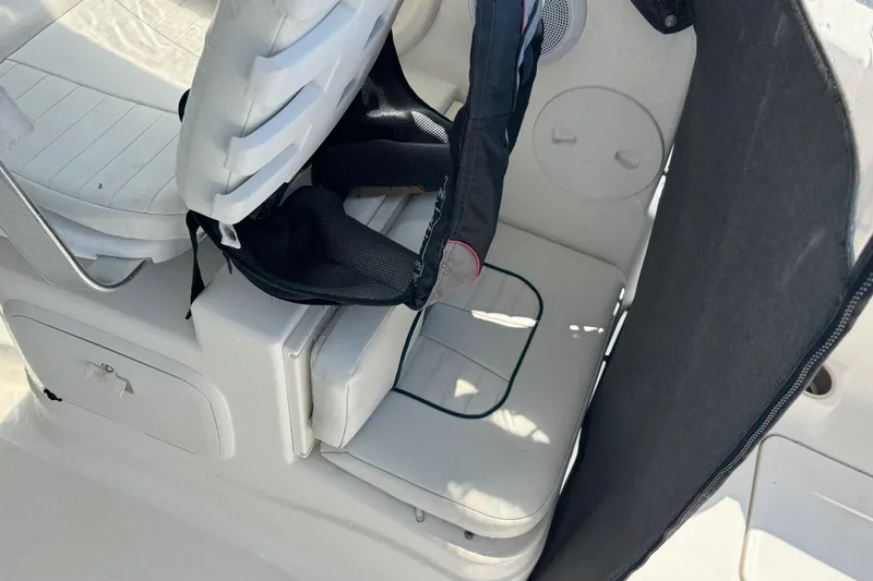 Slide: The Image of Interior seating of 2016 Wellcraft 252 Coastal boat, featuring white cushioned seats. - 29