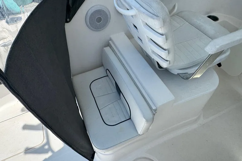 Slide: The Image of 2016 Wellcraft 252 Coastal boat interior with cushioned seating and speaker. - 30