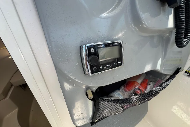 Slide: The Image of Control panel on a 2016 Wellcraft 252 Coastal boat, featuring a Fusion stereo system. - 32
