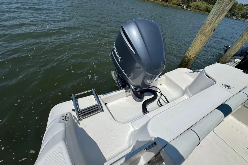 Slide: The Image of 2016 Wellcraft 252 Coastal boat with Yamaha outboard motor and swim ladder on water. - 4