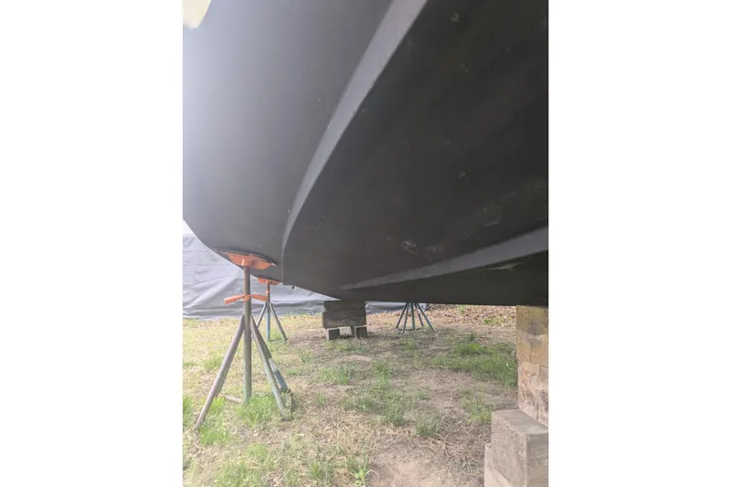 Slide: The Image of 2016 Wellcraft 252 Coastal boat hull on stands, viewed from below. - 9