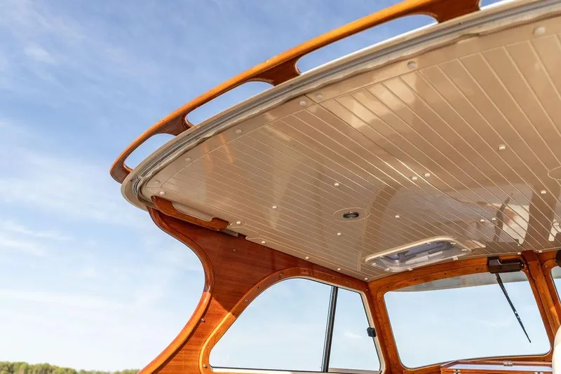 Slide: The Image of Hinckley Picnic Boat 36 Classic 2000, elegant wooden interior detail under clear blue sky. - 10