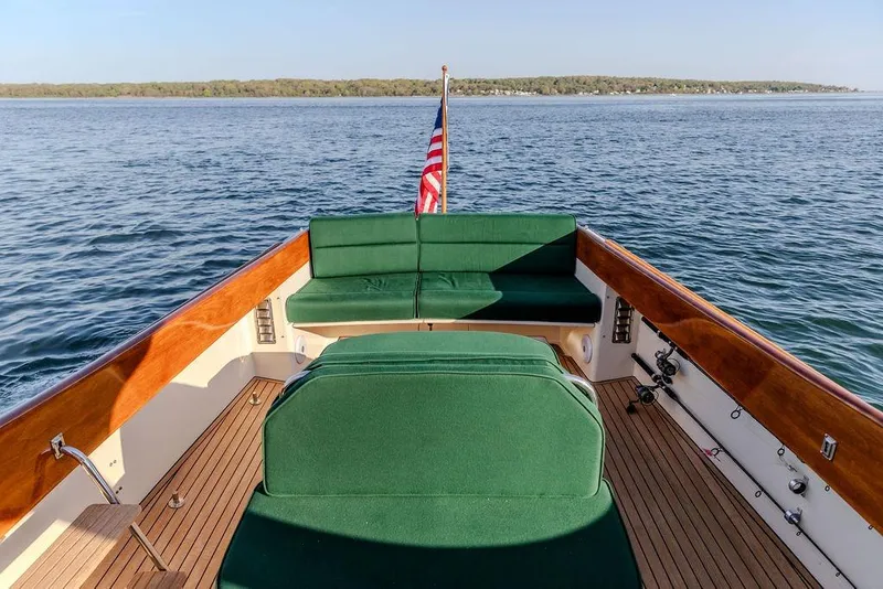 Slide: The Image of Hinckley Picnic Boat 36 Classic, 2000 model, with green seating, cruising on calm waters. - 12