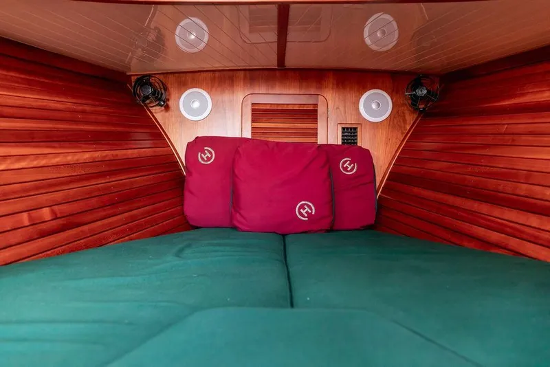 Slide: The Image of Cozy cabin interior of 2000 Hinckley Picnic Boat 36 Classic with wood paneling and cushions. - 15