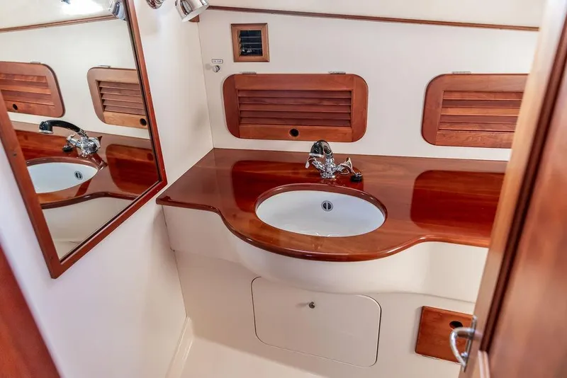 Slide: The Image of Hinckley Picnic Boat 36 Classic 2000 bathroom with wooden countertop and mirror. - 16