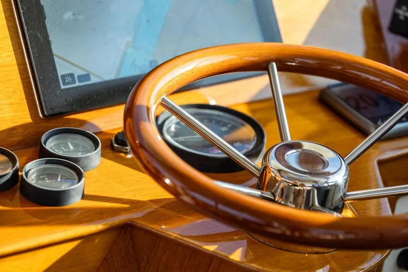 Slide: The Image of Steering wheel and gauges of 2000 Hinckley Picnic Boat 36 Classic cockpit. - 6