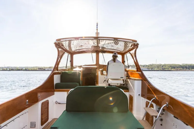 Slide: The Image of Hinckley Picnic Boat 36 Classic, 2000 model, cruising on calm waters under clear skies. - 8