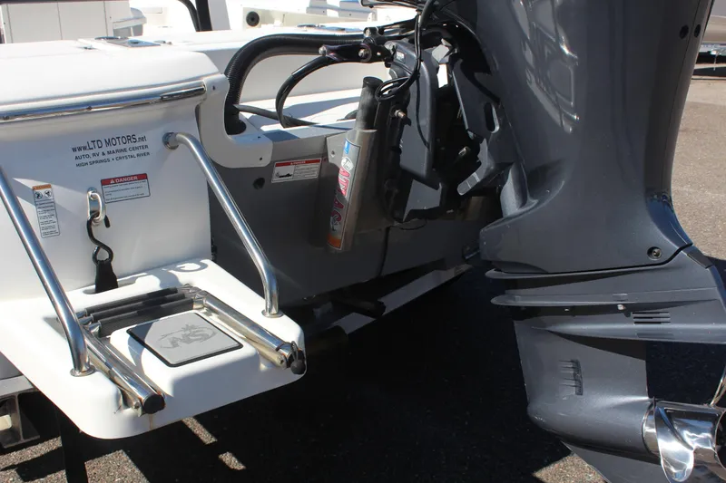 Slide: The Image of 2022 NauticStar 227 Bay boat stern with motor and swim platform. - 14