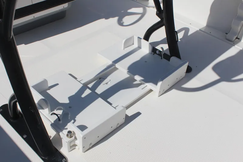 Slide: The Image of 2022 NauticStar 227 Bay boat interior with white deck and black metal supports. - 15