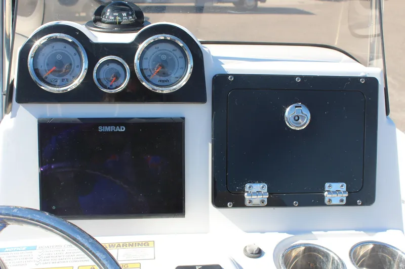 Slide: The Image of Dashboard of 2022 NauticStar 227 Bay boat with gauges and Simrad display. - 17
