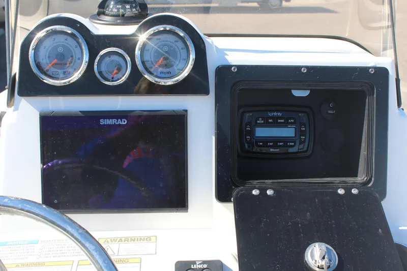 Slide: The Image of Dashboard of 2022 NauticStar 227 Bay boat with gauges and Simrad display. - 18