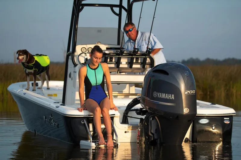 Slide: The Image of Manufacturer Provided Image: 2022 NauticStar 227 Bay boat with Yamaha 200 engine, people and dog onboard. - 2