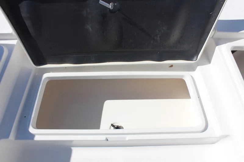 Slide: The Image of Open storage compartment on a 2022 NauticStar 227 Bay boat. - 21