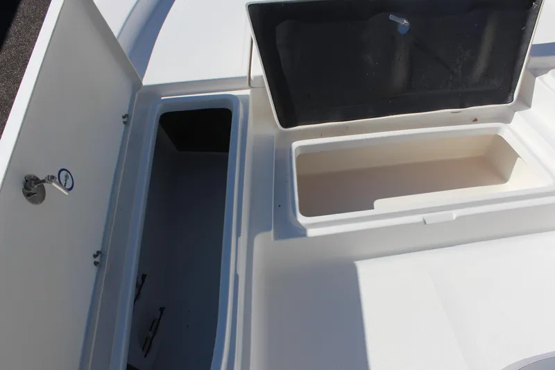 Slide: The Image of 2022 NauticStar 227 Bay boat storage compartments, open and ready for use. - 22