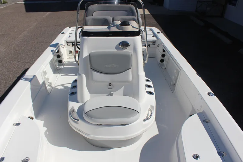Slide: The Image of 2022 NauticStar 227 Bay boat interior with seating and console, showcasing sleek design. - 27
