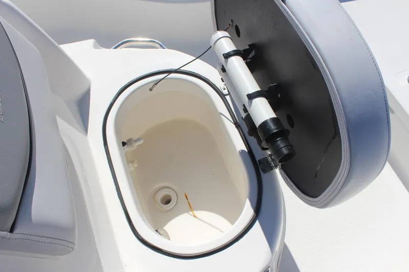 Slide: The Image of Open storage compartment on 2022 NauticStar 227 Bay boat, featuring a white interior. - 29
