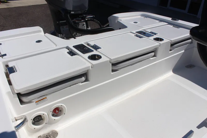 Slide: The Image of 2022 NauticStar 227 Bay boat interior with seating and storage compartments. - 31