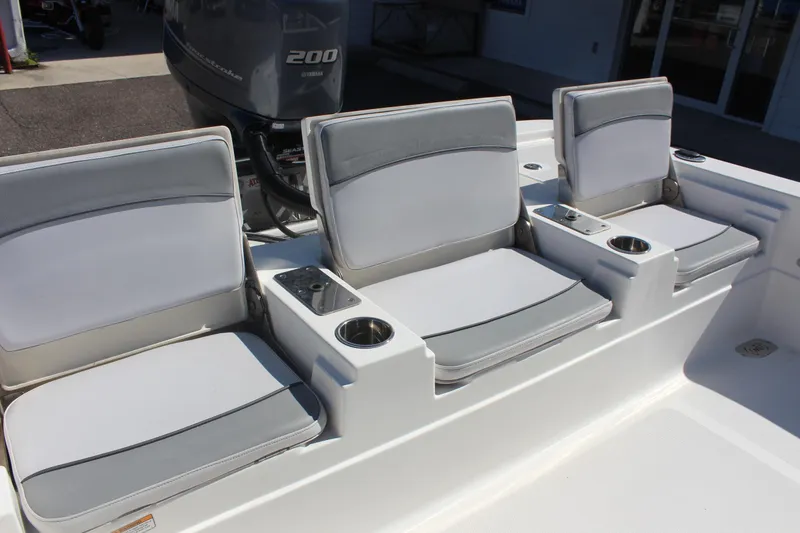 Slide: The Image of 2022 NauticStar 227 Bay boat seating with cup holders and Yamaha 200 engine. - 32