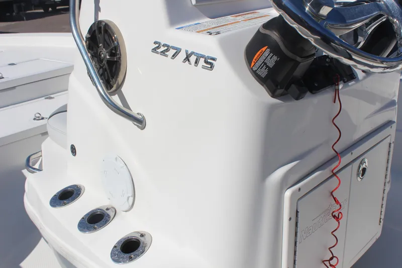Slide: The Image of 2022 NauticStar 227 Bay boat console with steering wheel and controls. - 38