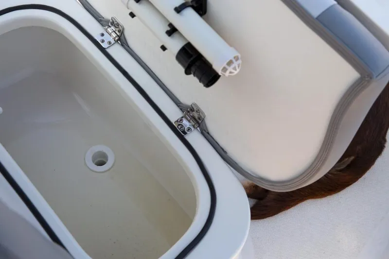 Slide: The Image of Manufacturer Provided Image: Open storage compartment on a 2022 NauticStar 227 Bay boat. - 5