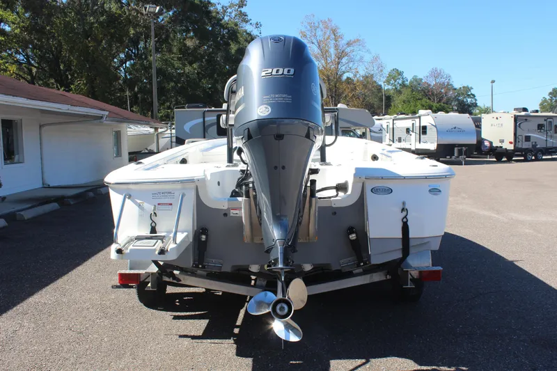 Slide: The Image of 2022 NauticStar 227 Bay boat with Yamaha 200 engine, parked outdoors. - 7