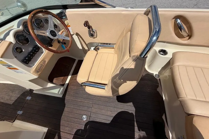 Slide: The Image of 2011 Chris-Craft Launch 22 Heritage Edition boat interior with beige seating and wooden accents. - 11