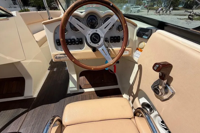 Slide: The Image of 2011 Chris-Craft Launch 22 Heritage Edition boat interior with classic steering wheel and controls. - 12