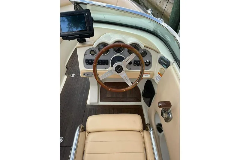 Slide: The Image of 2011 Chris-Craft Launch 22 Heritage Edition dashboard with wooden steering wheel and modern controls. - 14