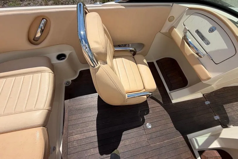 Slide: The Image of 2011 Chris-Craft Launch 22 Heritage Edition interior with beige seating and wooden flooring. - 15