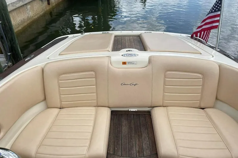 Slide: The Image of 2011 Chris-Craft Launch 22 Heritage Edition boat interior with beige seating and American flag. - 21