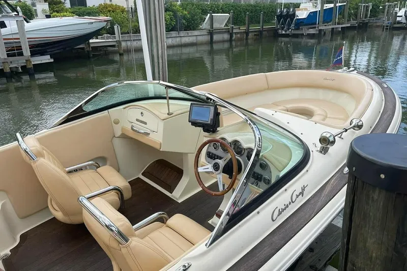 Slide: The Image of 2011 Chris-Craft Launch 22 Heritage Edition boat with elegant interior docked by the water. - 4