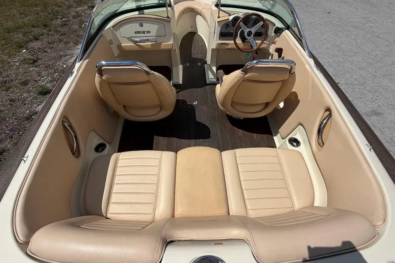 Slide: The Image of 2011 Chris-Craft Launch 22 Heritage Edition interior with beige leather seats and wooden flooring. - 5