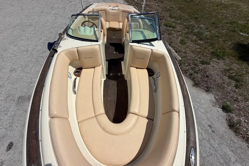 Slide: The Image of 2011 Chris-Craft Launch 22 Heritage Edition boat with beige seating and open cockpit. - 7