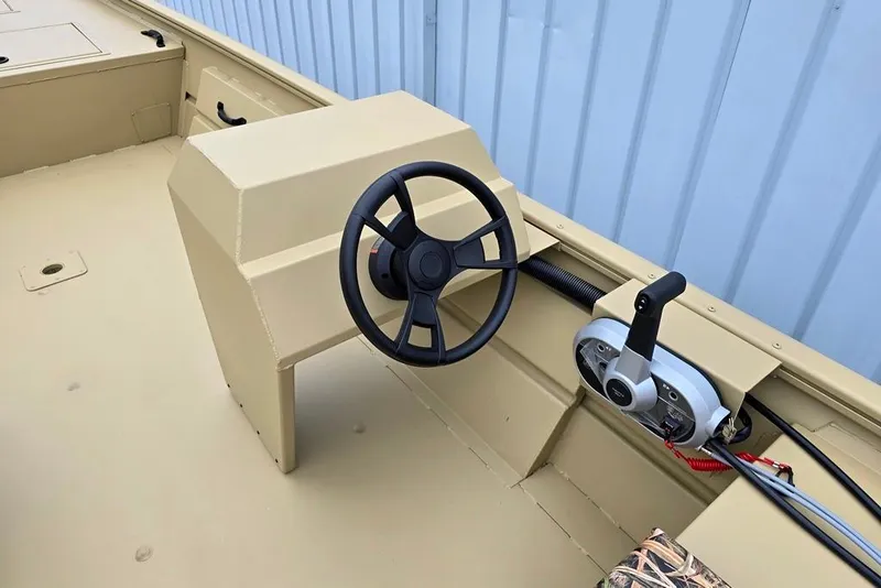 Slide: The Image of 2026 Lowe Roughneck RX2070 Tiller boat interior with steering wheel and control panel. - 2