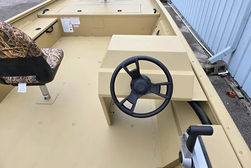 Slide: The Image of 2026 Lowe Roughneck RX2070 Tiller boat interior with steering wheel and camo seat. - 3