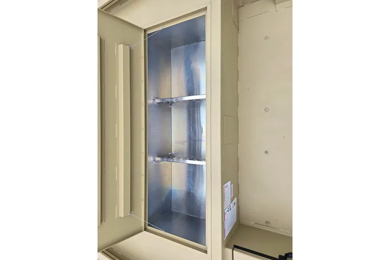 Slide: The Image of Empty beige metal cabinet with two shelves, viewed from the side. - 5
