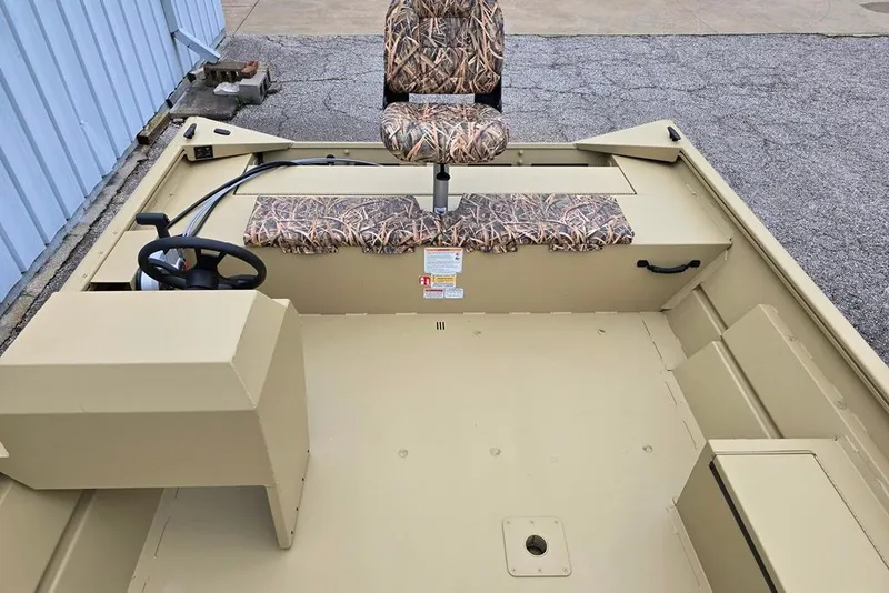 Slide: The Image of 2026 Lowe Roughneck RX2070 Tiller boat interior with camo seating and steering console. - 6