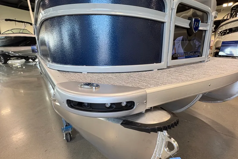 Slide: The Image of 2027 Premier 200 Sunscape RL - CL pontoon boat in showroom, showcasing sleek design and features. - 18