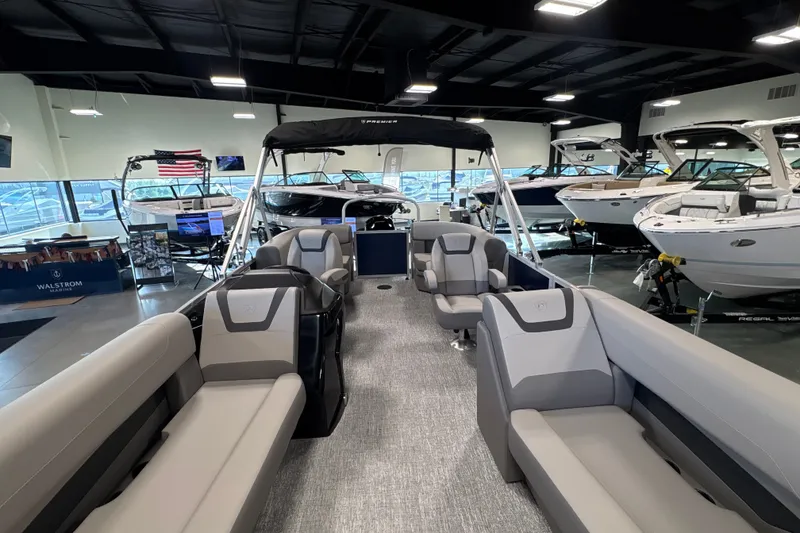 Slide: The Image of 2027 Premier 200 Sunscape RL - CL pontoon boat interior in showroom with luxury seating. - 11