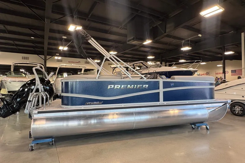 Slide: The Image of 2027 Premier 200 Sunscape RL - CL pontoon boat displayed indoors. - 2