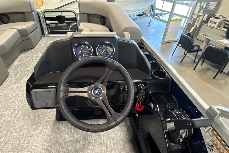 Slide: The Image of 2027 Premier 200 Sunscape RL - CL boat dashboard with steering wheel and gauges. - 12