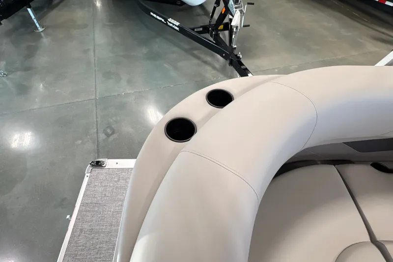 Slide: The Image of Premier 200 Sunscape RL - CL 2027 boat interior with beige seating and cup holders. - 7