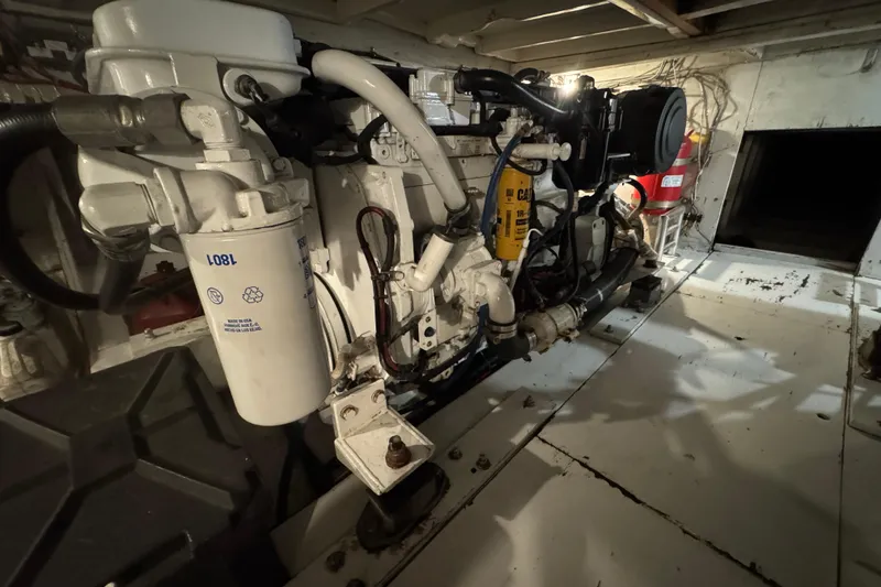 Slide: The Image of Engine room of 1990 Buddy Cannady 57 Custom Carolina boat, showcasing mechanical components. - 2