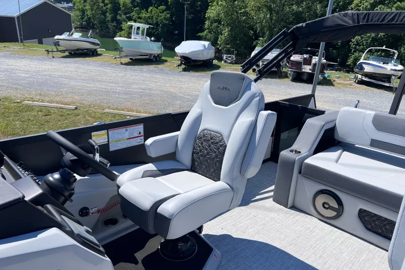 Slide: The Image of Captain's seat of 2026 Alera M23L boat, with steering wheel and dashboard. - 10